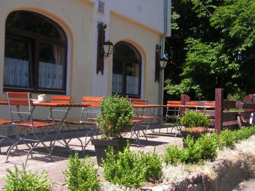 a group of tables and chairs in front of a building at Hotel Sternen in Lenzkirch