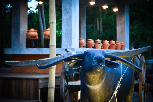a statue of a bull with antlers on its head at The Mud - Eco Hotel in Ban Bang Po