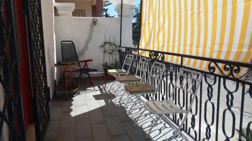 a balcony with two chairs and a fence at Casa Bianca da Giusy in Birgi Vecchi