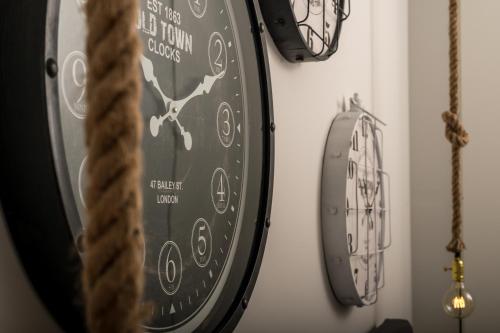 a clock hanging on a wall in a room at Filoxenia Hotel & Spa in Kalavrita