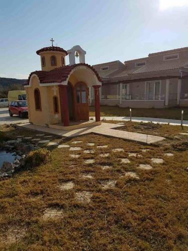 a small building with a cross on top of it at Sidari Waterpark in Sidari