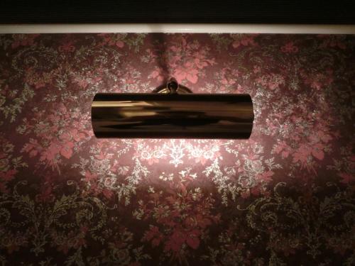 a light fixture hanging from a red wall at Hotel Hyper Noah (Adult Only) in Sakai