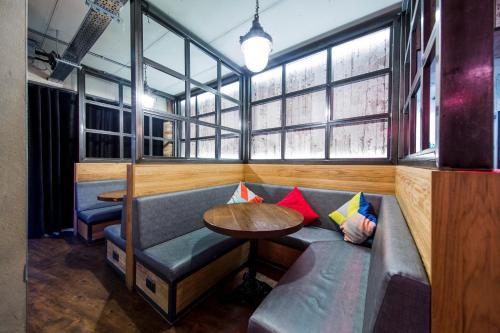 a room with a couch and a table and windows at Generator London in London