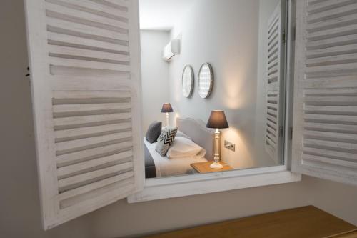 a room with a window and a chair and a lamp at Filoxenia Hotel & Spa in Kalavrita