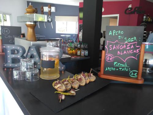 a bar with some food on a black counter at Cap Océan in Seignosse