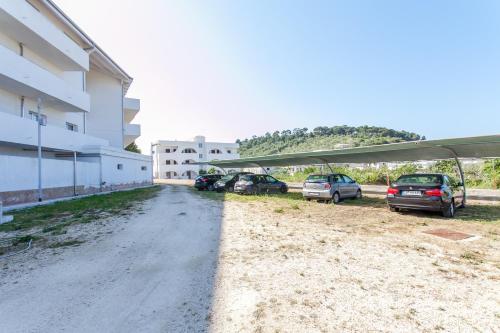 a parking lot with cars parked next to a building at Hotel Scialì in Vieste