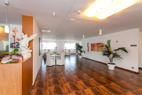 an empty office with plants and tables in a room at Hotel Scialì in Vieste