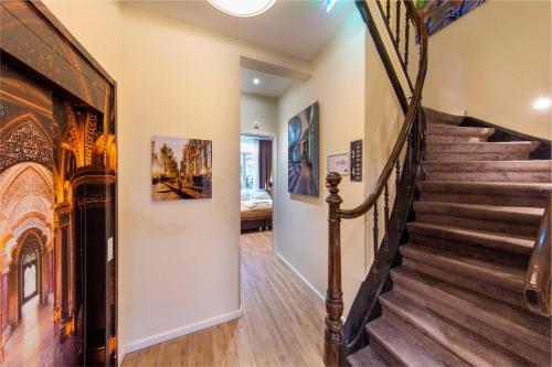 a staircase in a home with wood floors and a stair case at Royal Plaza Hotel Amsterdam in Amsterdam