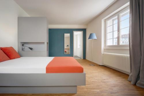 a bedroom with a bed and a large window at Josephine's Guesthouse - ! WOMEN ONLY ! in Zürich