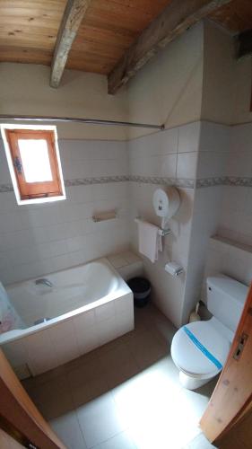 a bathroom with a tub and a toilet and a sink at Stou Kir Yianni in Omodos