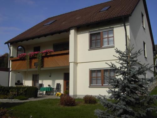 a white house with a brown roof at Ferienwohnung "Am Muschwitztal" Bad Steben / Carlsgrun in Bad Steben