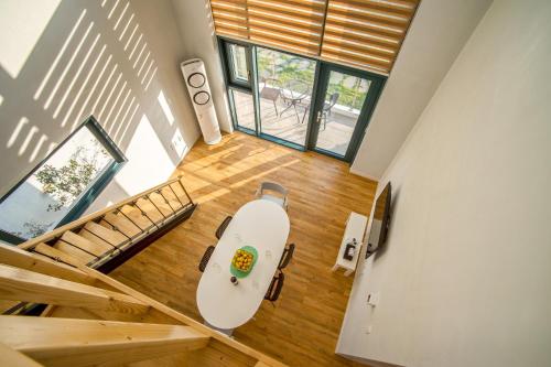 an overhead view of a living room with a table and stairs at Poema Stay Pension in Jeju