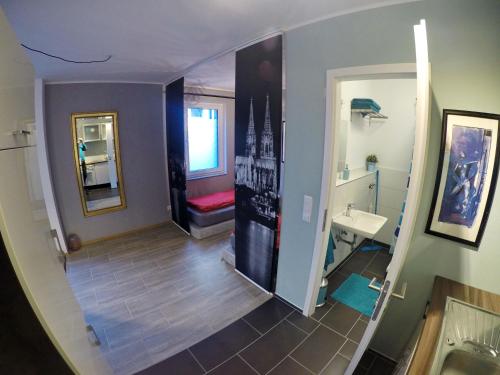 a small bathroom with a sink and a mirror at Apartment Christian in Cologne