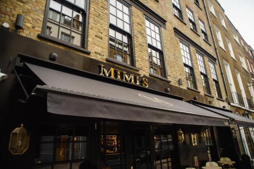 a store front of a building with a black awning at Mimi's Hotel Soho in London