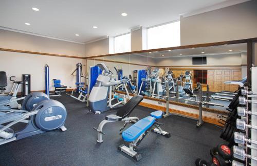 a gym with treadmills and cardio equipment and mirrors at Leonardo Hotel Inverness in Inverness