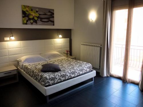 una camera da letto con un letto con un cuscino sopra di B&B Villa Letizia Inn a Castelbuono