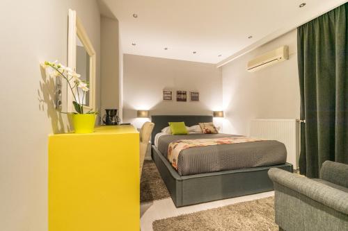 a bedroom with a bed and a yellow dresser at Filoxenia Hotel & Spa in Kalavrita