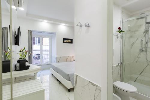 a white bathroom with a toilet and a shower at Little Aurelius in Rome