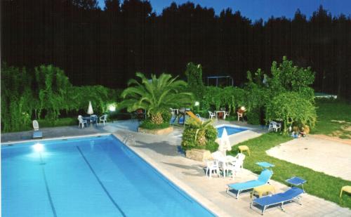 uma piscina com mesas e cadeiras ao lado em B&B RosAngelo em Mirabella Imbaccari