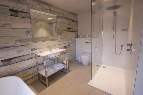 a bathroom with a sink and a shower and a toilet at The Peacock at Barlow in Chesterfield