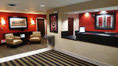 a waiting room with chairs and a television in a hotel at Extended Stay America Suites - Memphis - Germantown West in Memphis