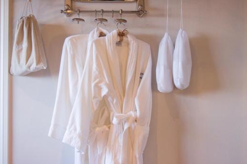 a white robe is hanging on a rack at The Peacock at Barlow in Chesterfield
