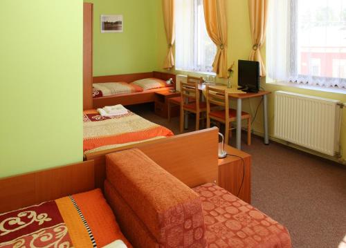 A bed or beds in a room at Penzion Česká Koruna