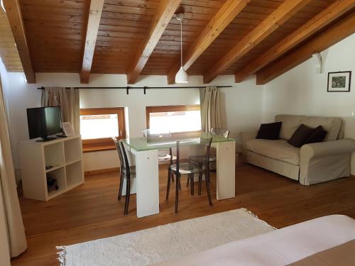 a living room with a table and a couch at Aqua Apartments Spa Housemuhlbach in Sappada