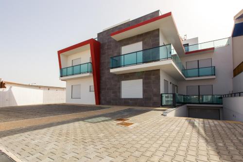 a large apartment building with a large patio at Luxury Apartments Baleal in Baleal