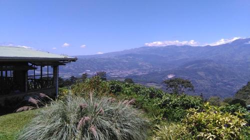 a view of a valley with mountains in the background at Finca Y Granja Loma Bonita in Turrialba