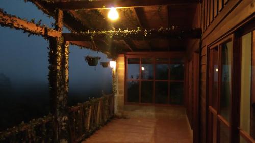 a room with a door and a window at night at Finca Y Granja Loma Bonita in Turrialba