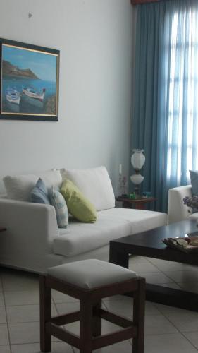 a living room with a white couch and a table at Hotel Charissi in Mýkonos City