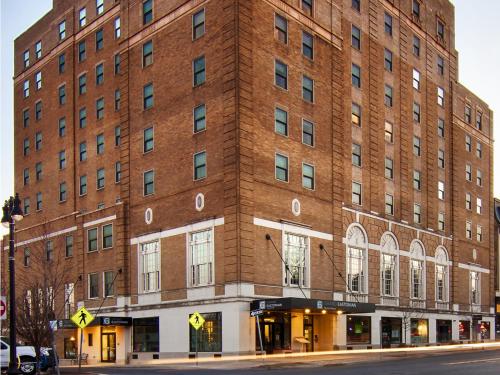 a large brick building on the corner of a street at Grand Eastonian Hotel & Suites in Easton