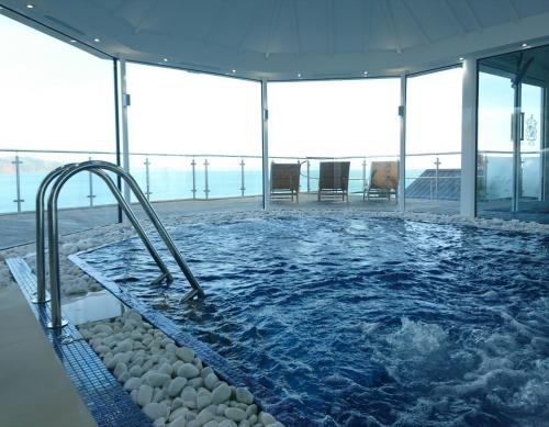a swimming pool with a slide in a building at Cary Arms & Spa in Torquay