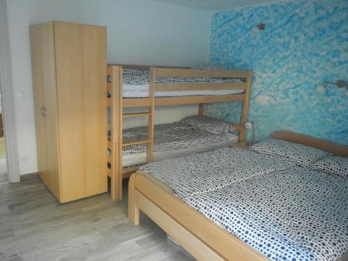 a bedroom with two bunk beds and a cabinet at Danijela & Gregor in Rateče