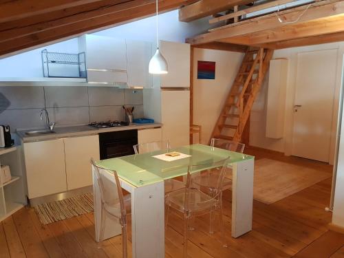a kitchen with a table and chairs in a room at Aqua Apartments Spa Housemuhlbach in Sappada