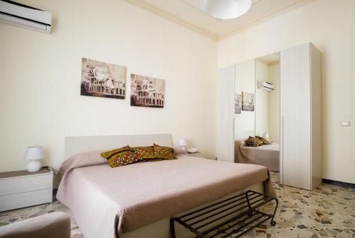 a white bedroom with a bed and a mirror at La Cubba in Palermo