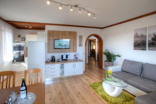 a living room and kitchen with a couch and a table at Mathiasl Panorama Ferienwohnungen in Bodensdorf