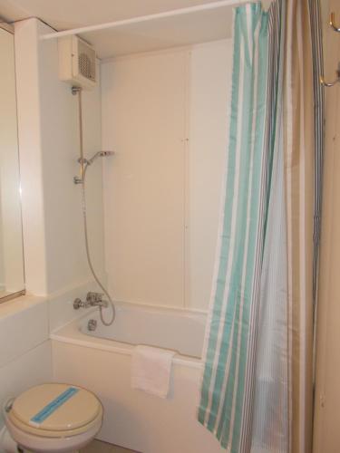 a bathroom with a shower and a toilet and a tub at Sul mare di Punta Ala in Punta Ala