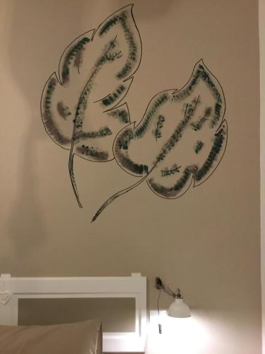 two flower stencils on a bedroom wall at Palazzo Kapece in Monopoli