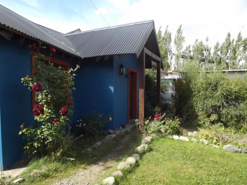 a blue house with a garden in front of it at Kiritina´s House Homestay in El Calafate
