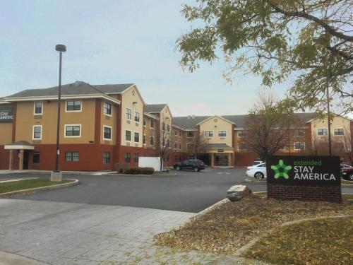 a sign in a parking lot in front of a building at Extended Stay America Suites - Salt Lake City - West Valley Center in West Valley City