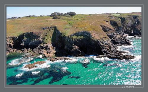 an aerial view of the ocean and a rocky coastline at Hôtel de la Baie des Trépassés in Plogoff