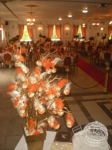 a banquet hall with a table with orange flowers at Chateau de la Chapelle des Bois in Fleurie