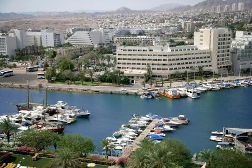 a group of boats docked in a harbor in a city at Caesar Premier Eilat Hotel in Eilat