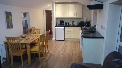 a kitchen and dining room with a table and chairs at Esker House in Donegal
