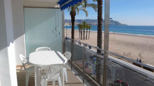 a balcony with a table and a view of the beach at Apartamentos Ulia in Benidorm