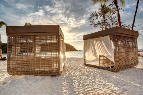 two birds cages on a beach with the ocean at Royalton Saint Lucia, An Autograph Collection All-Inclusive Resort in Gros Islet