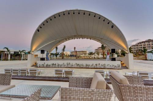 a large building with chairs and tables in a courtyard at Royalton Hideaway Saint Lucia, An Autograph Collection All-Inclusive Resort - Adults Only in Gros Islet