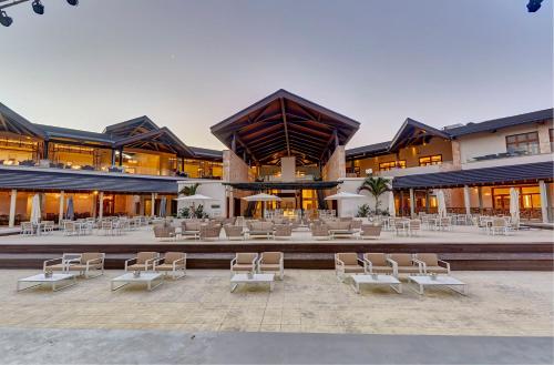 a large building with chairs and tables in front of it at Royalton Hideaway Saint Lucia, An Autograph Collection All-Inclusive Resort - Adults Only in Gros Islet